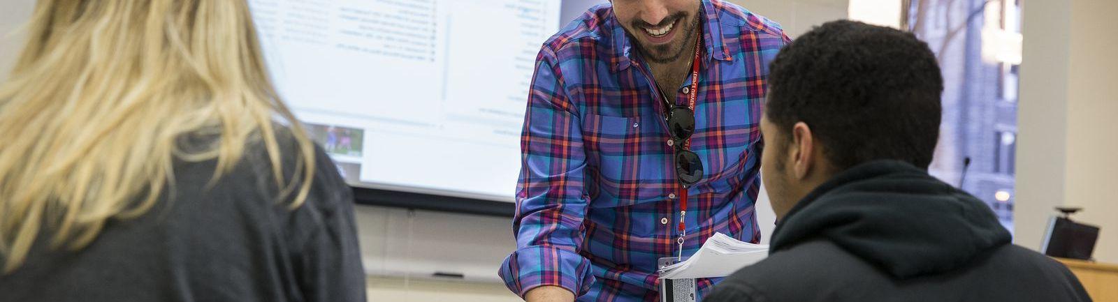 A College of Public Health professor provides personal instruction to students.